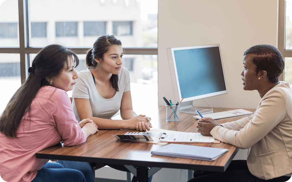 Three women sitting at a table.